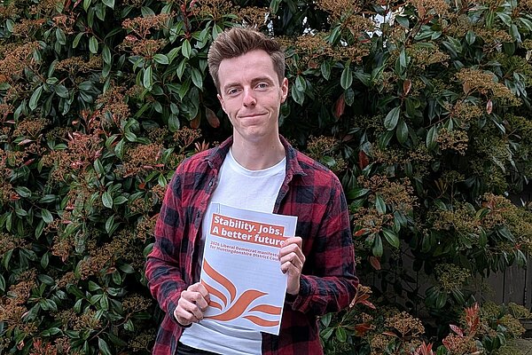 Cllr Nathan Hunt holding the 2026 HDC LDs manifesto