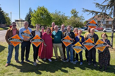 Ed Davey with Huntingdon activists holding orange placards reading Liberal Democrats
