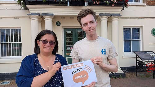 Cllr Nathan Hunt and Cllr Jo Harvey holding a sign that reads “We’re backing Ask for Angela”