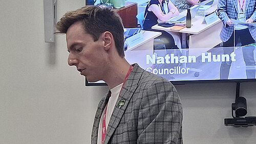 Cllr Nathan Hunt speaking at a podium